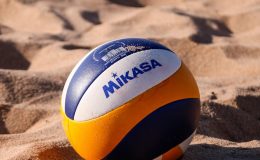 Volleyball on sandy beach in Salvador, Brazil. Perfect for summer sports enthusiasts.